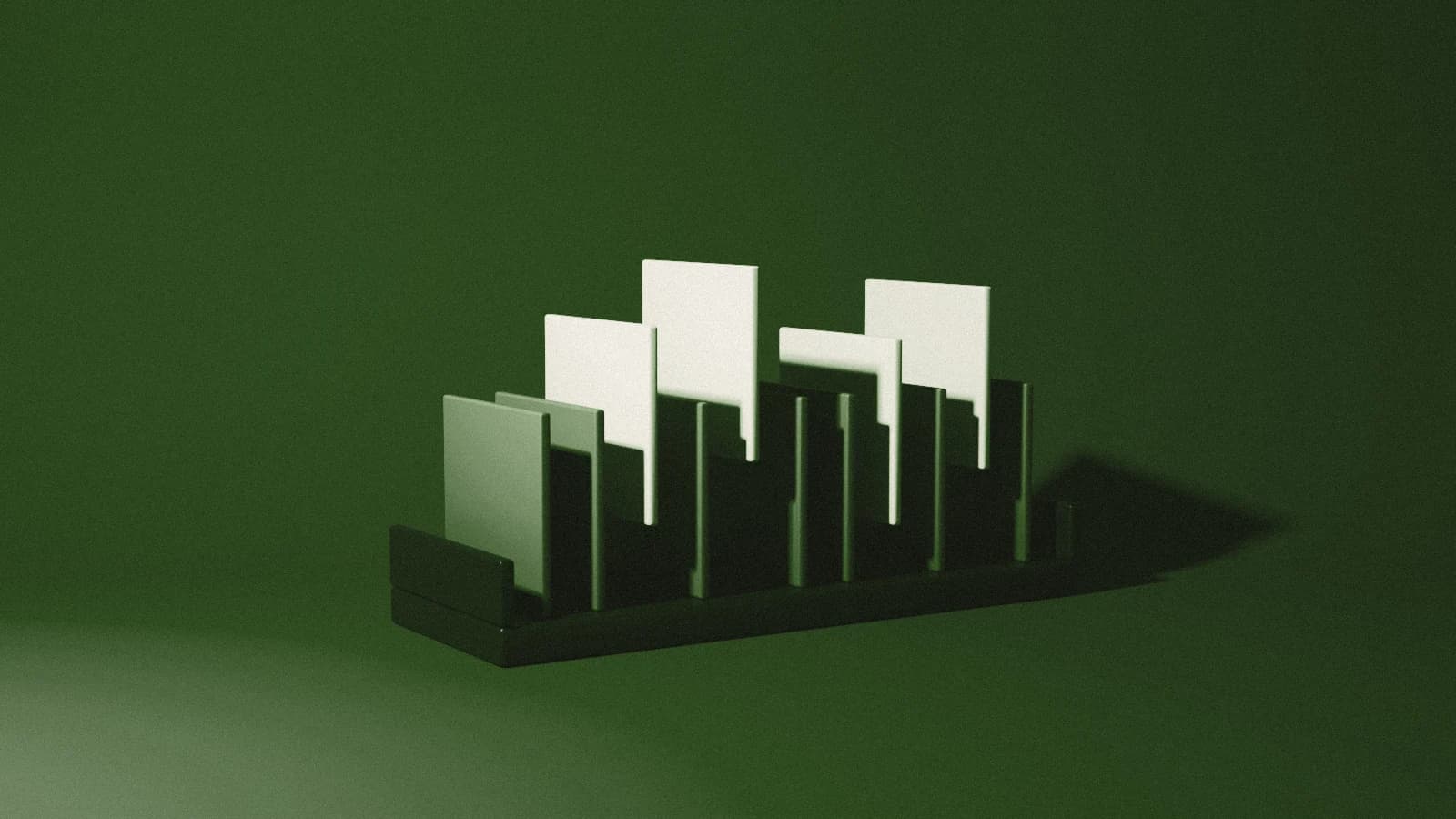 A graphite rack of plates, four lifted in bone, on Moss